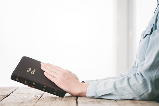 Christian Marriage Counselor Holding Bible While Waiting for Orlando Couple