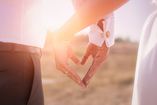 Tampa Christian Couple Who Had Marriage Counseling Making a Heart Sign Using Hands