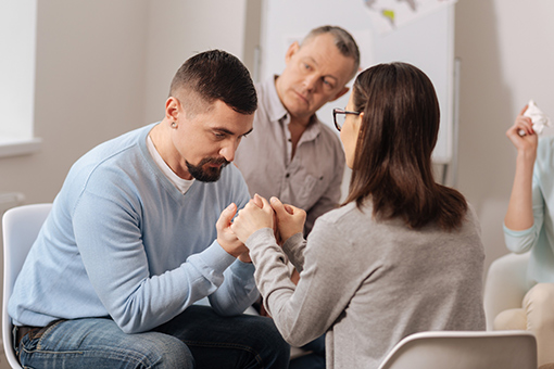 Husband and Wife Forgiving Each Other During Marriage Counseling Session in an Office in Tampa FL