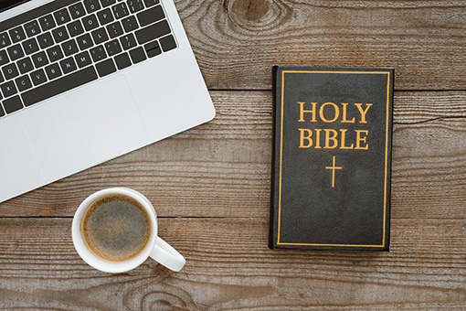 Coffee, Bible and Laptop To Be Used for Marriage Counseling of a Christian Couple