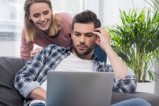 Couple Attending Marriage Counseling Session Using Laptop in Their Home in Tampa Florida