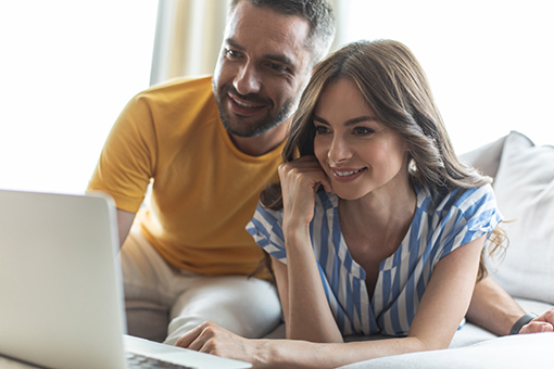 Engaged Christian Couple Attending Pre-Marriage Counseling Online On Their Laptop