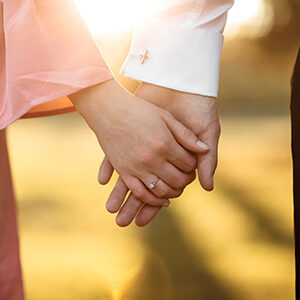 Engaged Couple Holding Hands On The Way to Christian Marriage Counseling Office